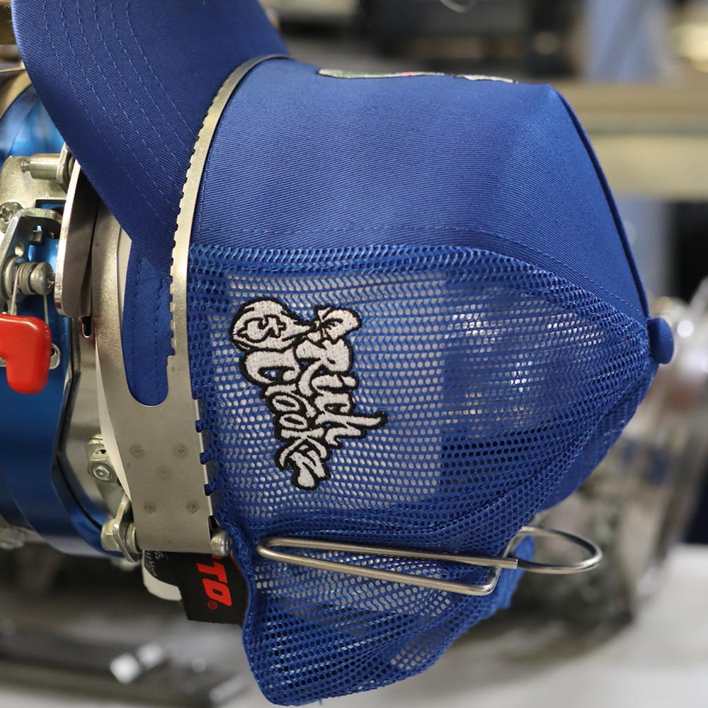 Close-up of a blue hockey glove with "shock" embroidered on it.