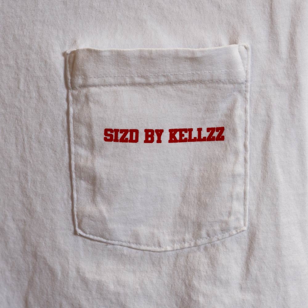 A white pocket with the text "sizd by kellz" embroidered in red.