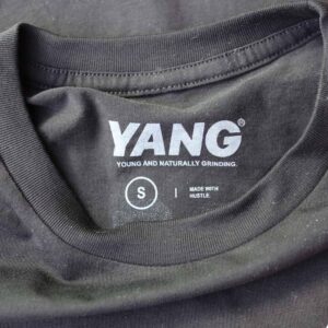 Detailed shot of the printed neck tag on the Bella + Canvas 3001 Unisex Jersey T-Shirt in black. Garment Decor’s custom neck tag branding provides a sleek, professional touch for the 'Can't Go Broke Est. 2017' design.