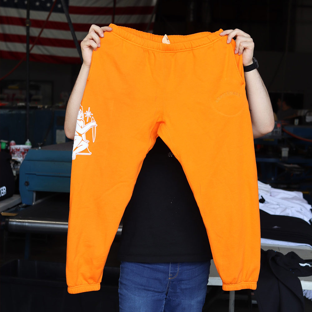 Customized screen printed joggers in orange full view