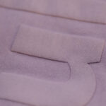 Close-up of the Kulti design tonal puff screen print on the back of an Upcycle LA lavender sweatshirt. The textured details, printed by Garment Decor, add a unique and premium finish to this eco-friendly apparel."