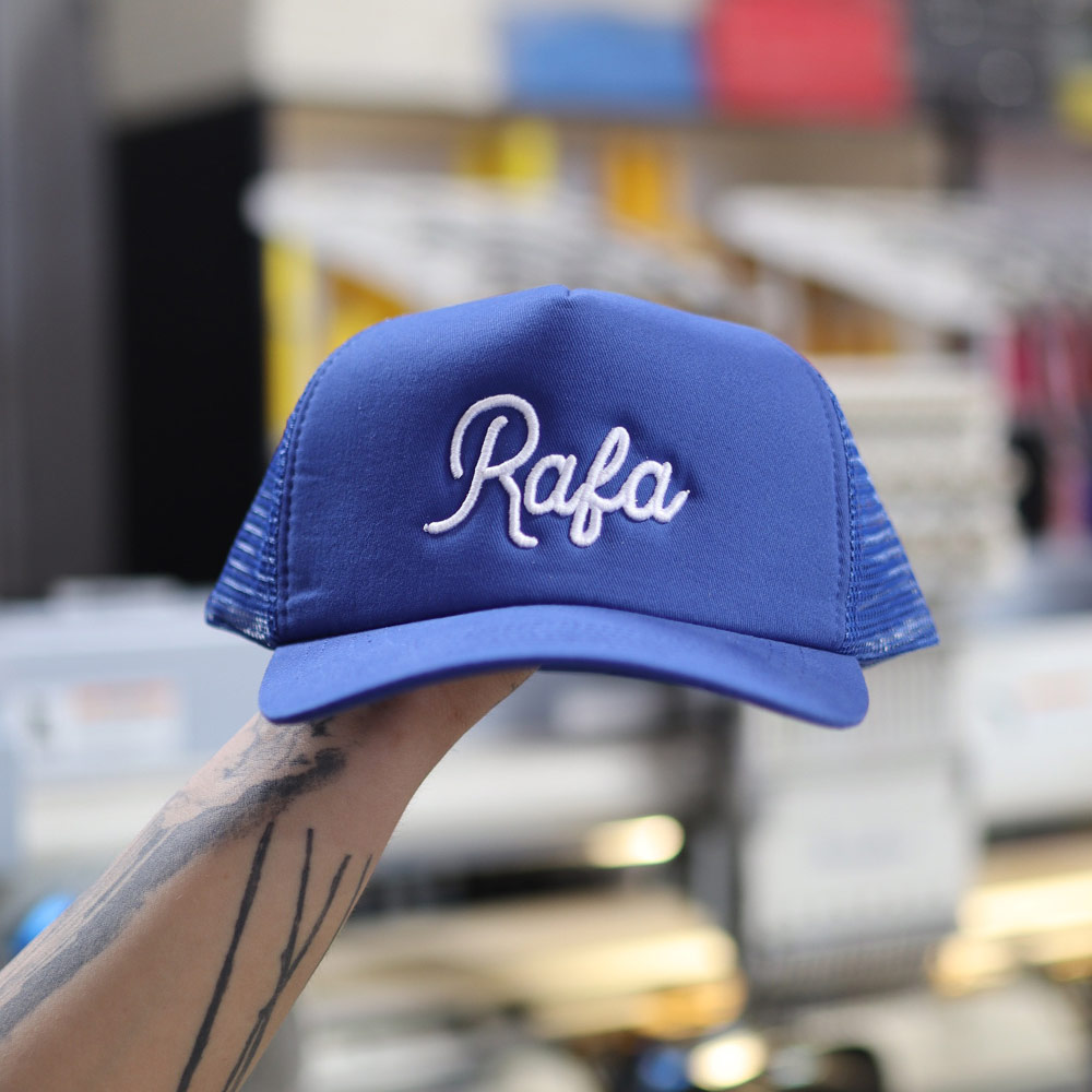 This is a photo of a royal blue embroidered hat with puff embroidery