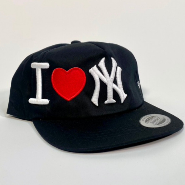 Front view of the YP Classics 5089M Premium Five-Panel Snapback Cap in black, showcasing the custom 3D embroidered I