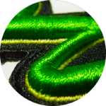Close-up view of green and black embroidered fabric.