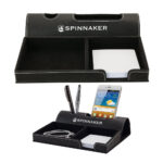 A black leather desk organizer with compartments for stationery and a mobile phone, featuring the "spinnaker" brand logo.