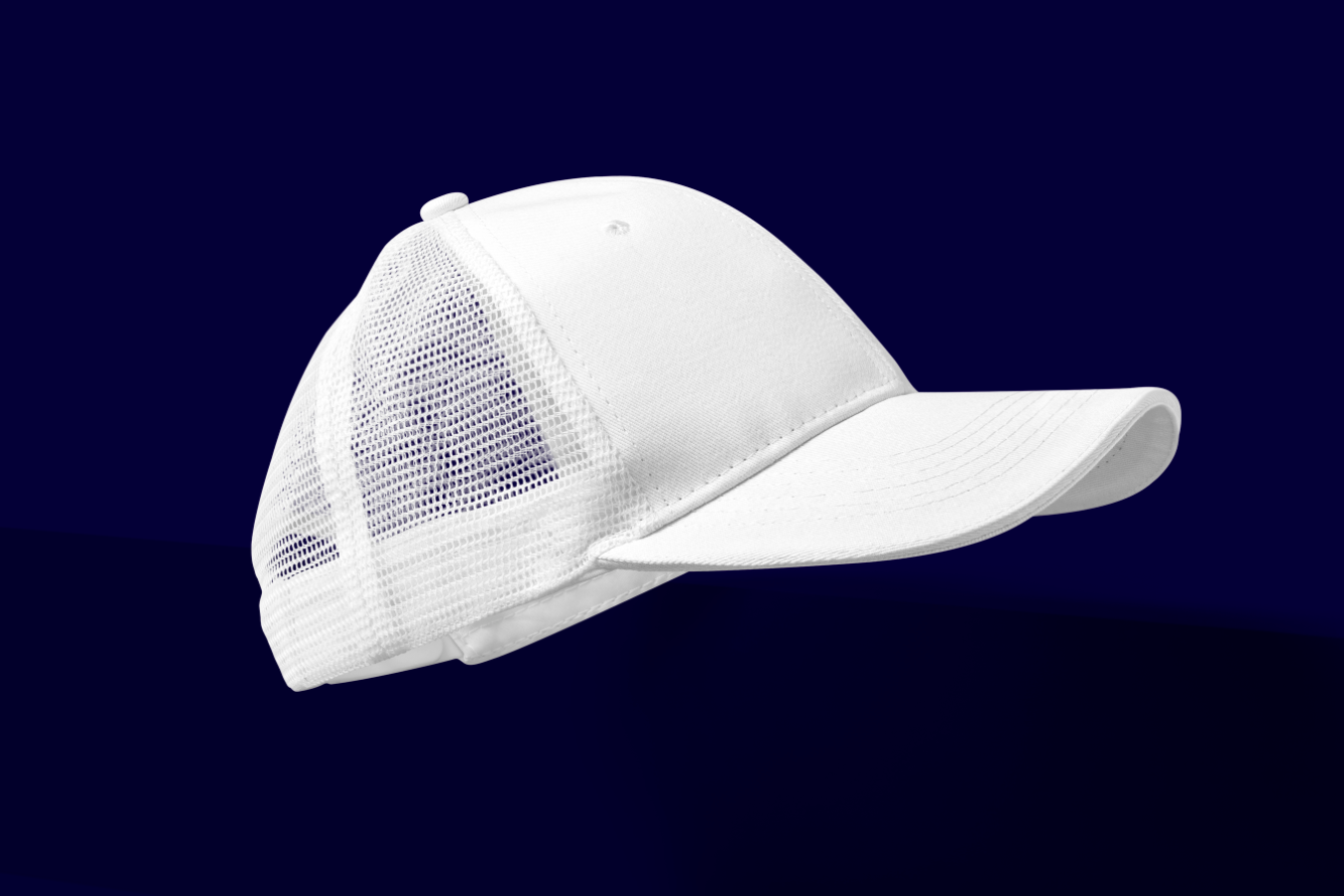 White baseball cap with mesh back on a blue background.