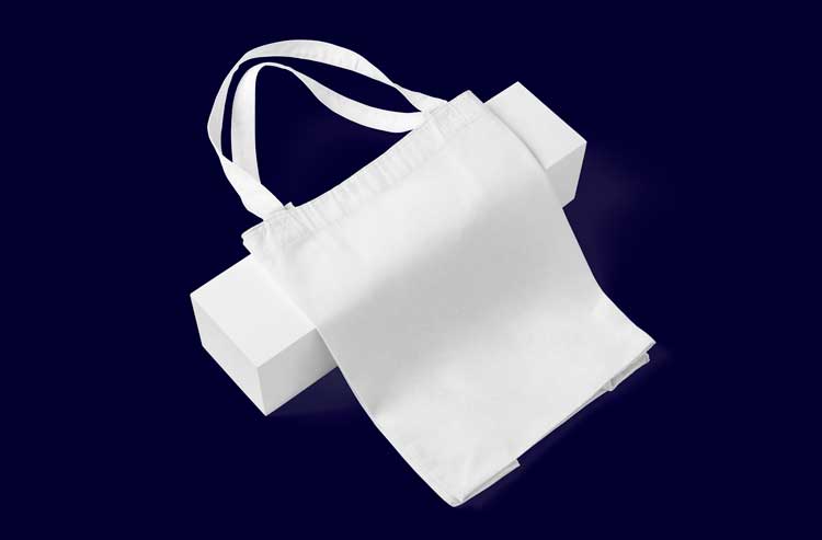 A white tote bag on a navy blue background.