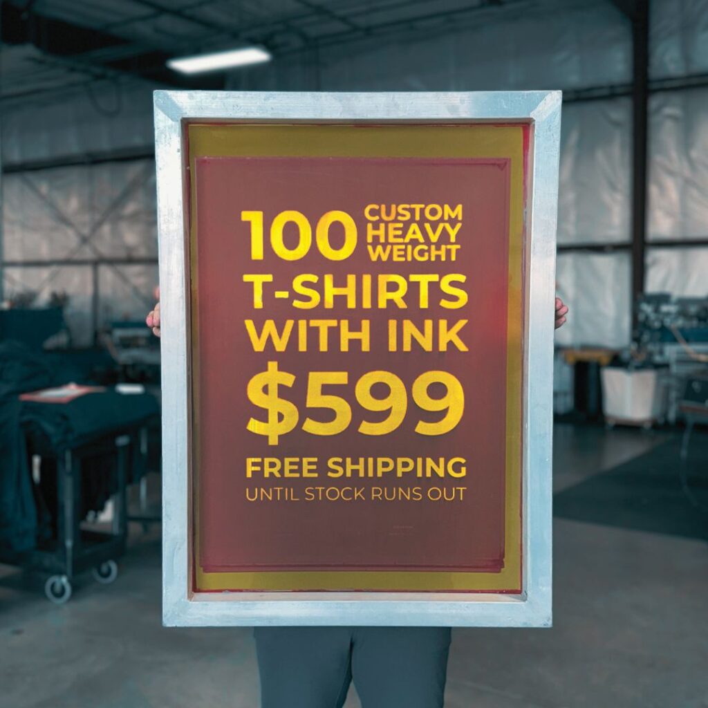 Person holding a promotional sign for Custom Printed Heavyweight Cotton T Shirts, offering 100 shirts for $599 with free shipping.