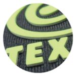 Close-up of a textured surface with the letters "tex" in a bright color, possibly part of a logo or brand name.