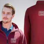 A man wearing a maroon zip-up jacket with a custom embroidered fleece logo on the front left side. The back view of the jacket, featuring the same logo in the center, is also shown. The background is plain grey.