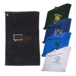 Five embroidered polo shirts in various colors and one personalized golf towel, each featuring different logos and text, displayed against a white background.