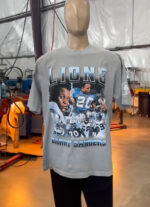 A mannequin displays "100 Custom Streetwear T-Shirts - Heavyweight Garment-Dyed Shirt With Screen Printing" featuring images of a football player number 20, with "Barry Sanders" printed at the bottom, in an industrial setting with various equipment in the background.