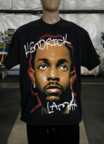 Mannequin wearing a black t-shirt with a large portrait of a man's face and the text "Kendrick Lamar" written on it from the product, 50 Custom Streetwear T-Shirts - Heavyweight Garment-Dyed Shirt With Screen Printing.