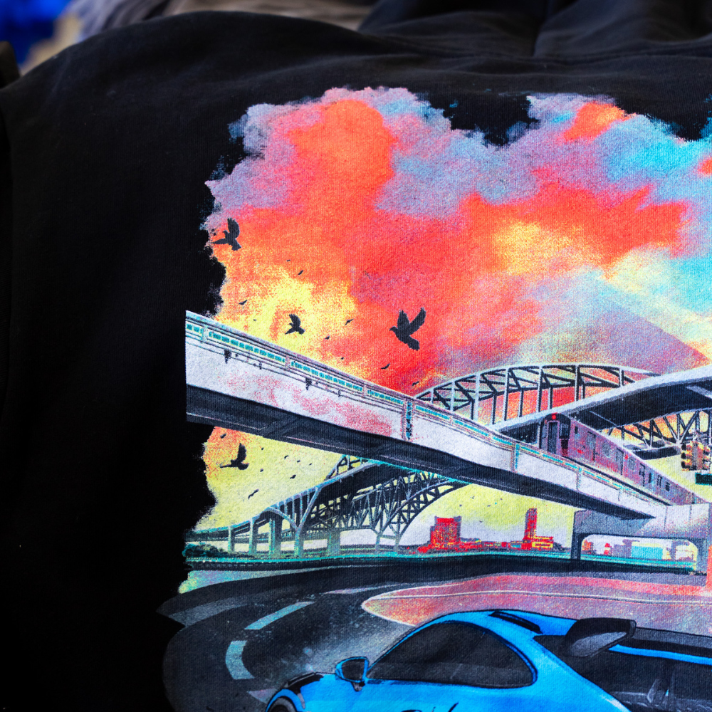 Zoomed in photo of black Independent Trading Co. IND420XD MAINSTREET 420GM HEAVYWEIGHT PULLOVER HOOD with custom street city artwork Digital Squeegee printed by Garment Decor