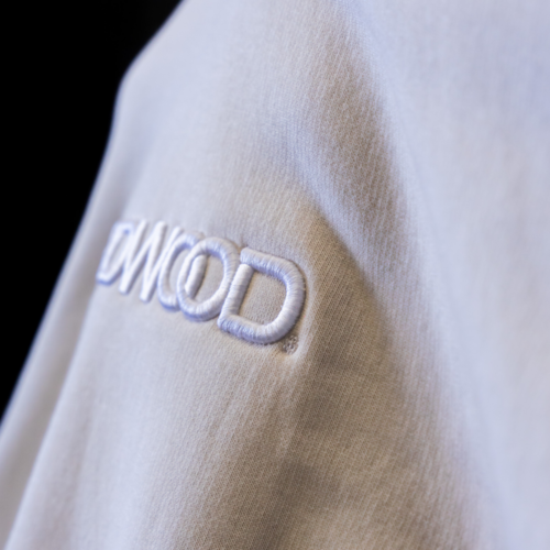 A zoomed-in front view shot of the AS Colour 5161 Relax Hoodie in bone with Hardwood LA’s design with custom puff embroidery embroidered by Garment Decor, highlighting its detailed texture and design quality that enhances any streetwear line.